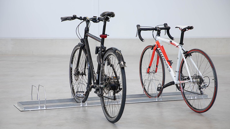 ground placed bike rack with two bikes